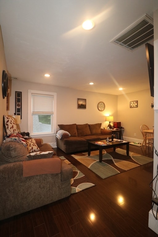 living room featuring dark wood-type flooring