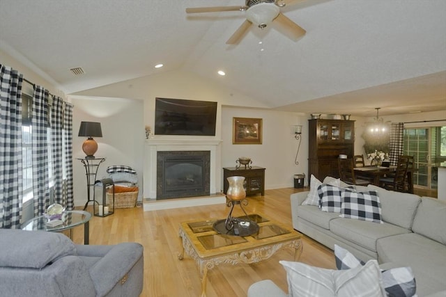 717 Northampton St Unit 41, Holyoke, MA 01040 - living room featuring vaulted ceiling, a glass covered fireplace, wood finished floors, a ceiling fan, and recessed lighting