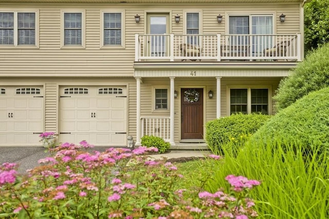 717 Northampton St Unit 41, Holyoke, MA 01040 - view of front of house with a balcony, a garage, a porch, and driveway