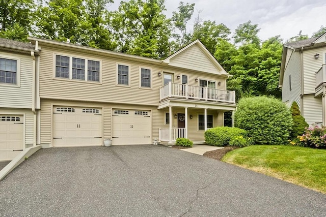 717 Northampton St Unit 41, Holyoke, MA 01040 - view of front of house featuring a balcony, driveway, and an attached garage