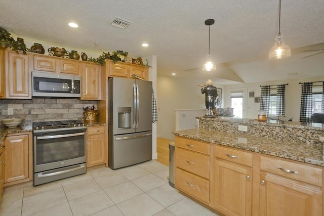 717 Northampton St Unit 41, Holyoke, MA 01040 - kitchen with stainless steel appliances, tasteful backsplash, plenty of natural light, decorative light fixtures, and a textured ceiling