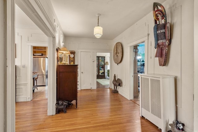 97 Stearns Rd, Brookline, MA 02446 - corridor with light wood-style flooring and radiator heating unit