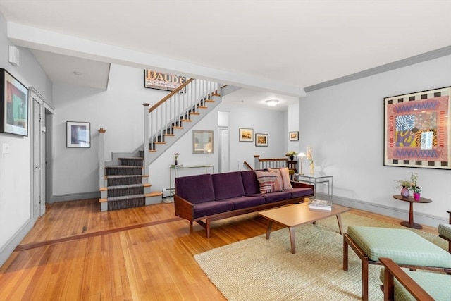 97 Stearns Rd, Brookline, MA 02446 - living area featuring light wood-type flooring, a baseboard heating unit, baseboards, and stairway