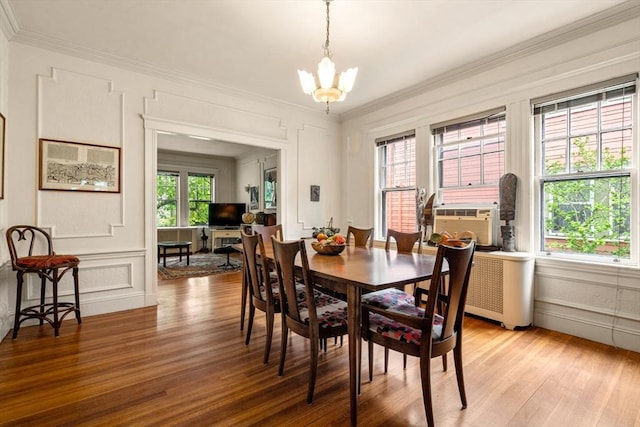97 Stearns Rd, Brookline, MA 02446 - dining area with crown molding, a chandelier, a decorative wall, light wood-style flooring, and cooling unit