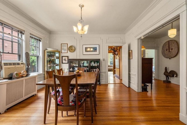 97 Stearns Rd, Brookline, MA 02446 - dining space featuring a chandelier, wood finished floors, crown molding, and cooling unit
