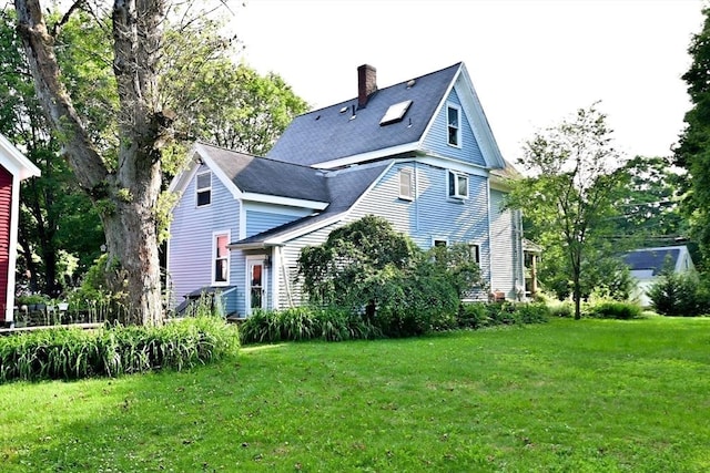 217 Asbury St, Hamilton, MA 01982 - back of house featuring a lawn, a chimney, and a shingled roof