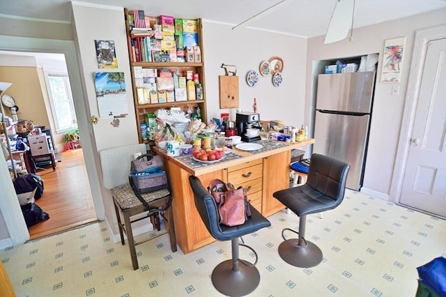 217 Asbury St, Hamilton, MA 01982 - kitchen featuring freestanding refrigerator, light floors, and crown molding