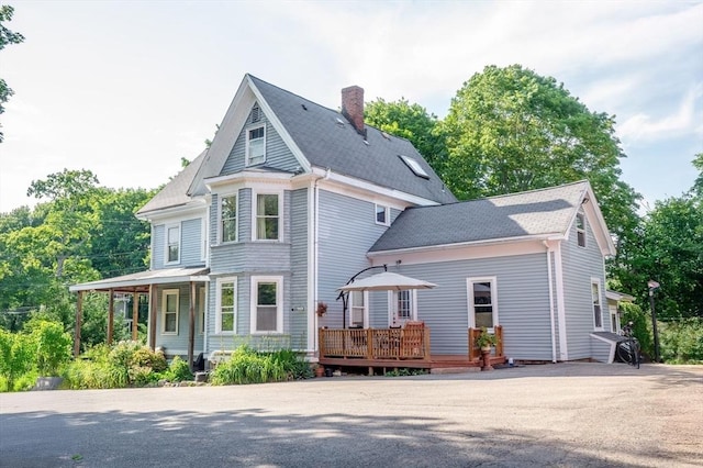 217 Asbury St, Hamilton, MA 01982 - view of front of home with a chimney, a deck, and roof with shingles