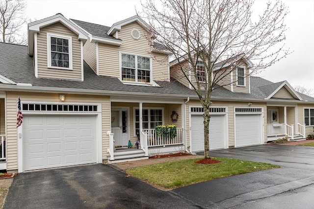 view of front of home with a porch, a shingled roof, and aphalt driveway
