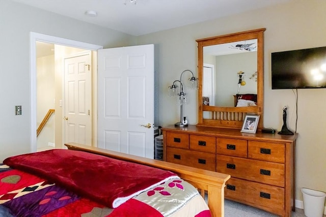 bedroom with baseboards and carpet