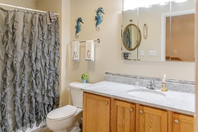 bathroom with toilet, a shower with shower curtain, and vanity