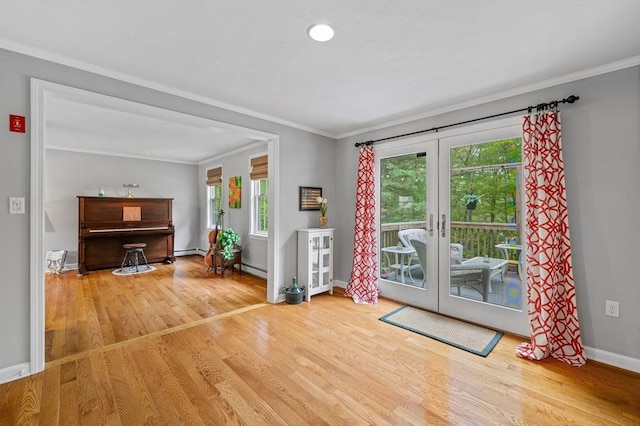 doorway with wood finished floors, baseboards, crown molding, french doors, and baseboard heating