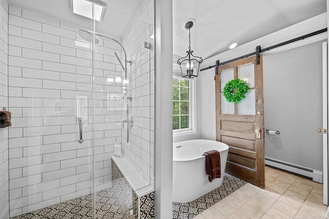 bathroom featuring baseboard heating, a freestanding tub, a stall shower, and tile patterned flooring
