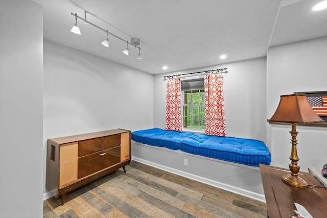 bedroom with wood finished floors, baseboards, recessed lighting, and rail lighting