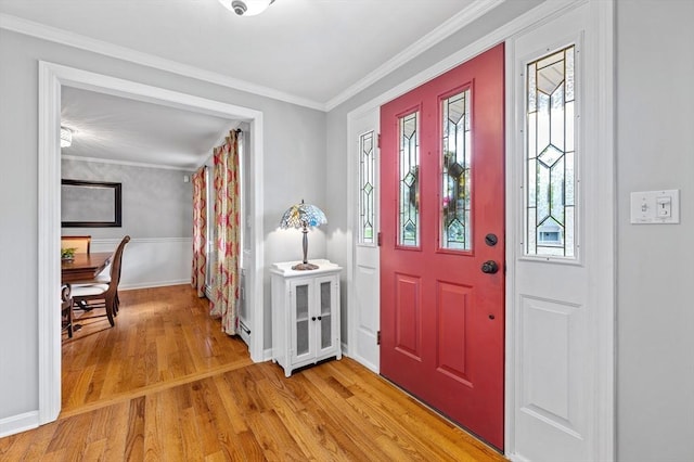 foyer entrance with light wood-style floors, plenty of natural light, ornamental molding, baseboards, and a baseboard radiator