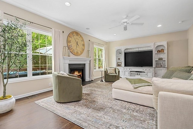 132 Hemmingway Pl, Wrentham, MA 02093 - living room featuring wood finished floors, a ceiling fan, a lit fireplace, baseboards, and recessed lighting
