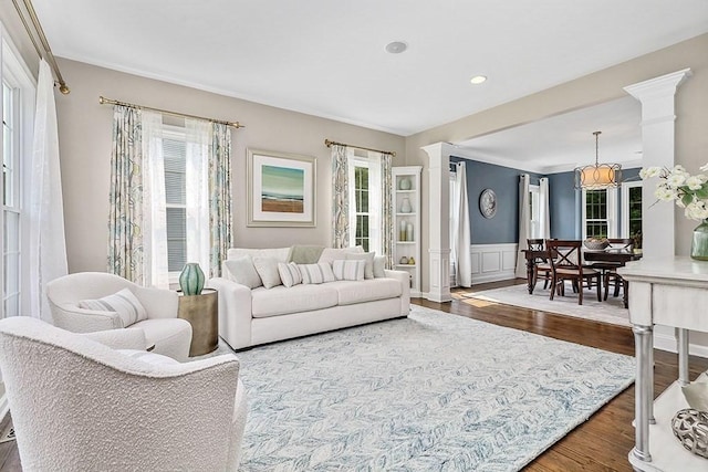 132 Hemmingway Pl, Wrentham, MA 02093 - living area featuring healthy amount of natural light, dark wood-style flooring, ornamental molding, wainscoting, and recessed lighting