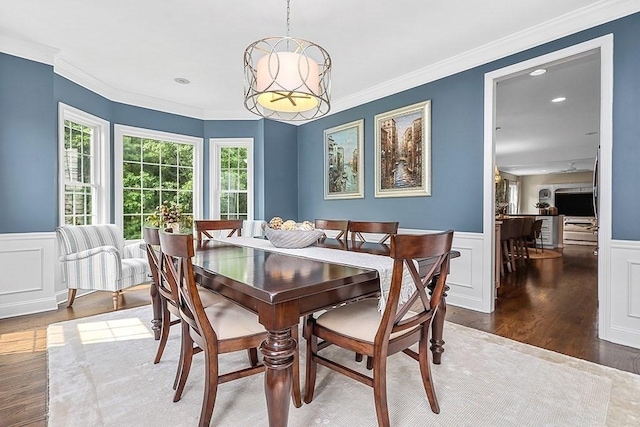 132 Hemmingway Pl, Wrentham, MA 02093 - dining room with wood finished floors, wainscoting, a decorative wall, and crown molding