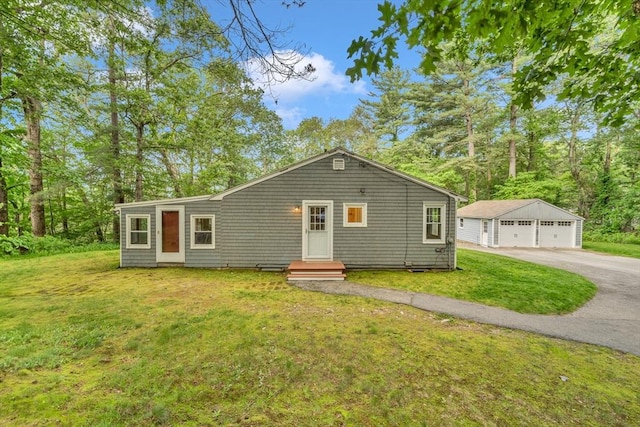 26 Beacon St, Amesbury, MA 01913 - view of front facade with a garage, an outdoor structure, a front lawn, and entry steps