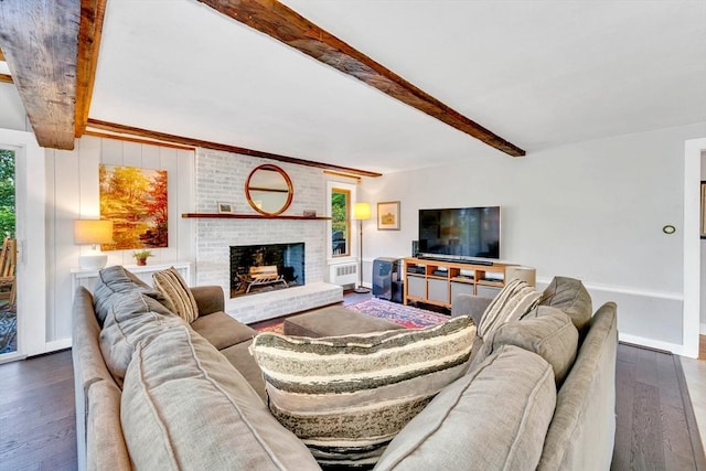 26 Beacon St, Amesbury, MA 01913 - living area featuring beamed ceiling, wood-type flooring, radiator heating unit, and a fireplace