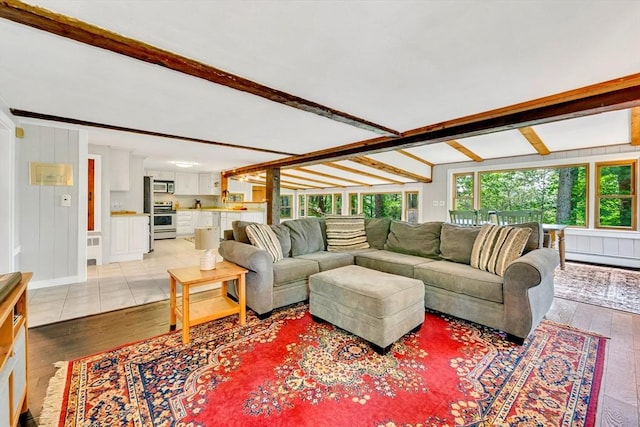 26 Beacon St, Amesbury, MA 01913 - living room featuring beamed ceiling, light wood finished floors, a baseboard heating unit, and radiator