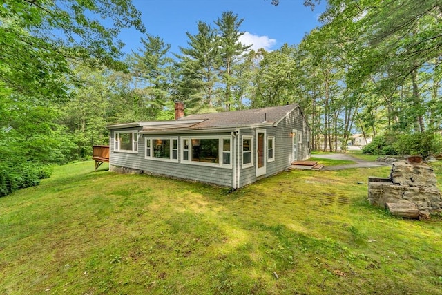 26 Beacon St, Amesbury, MA 01913 - back of house with a chimney, a lawn, and a deck