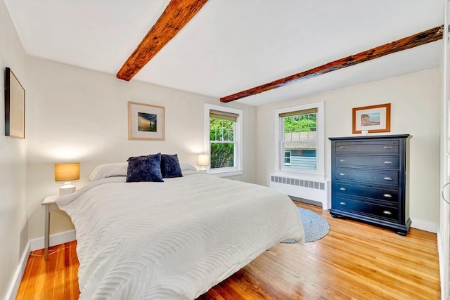 26 Beacon St, Amesbury, MA 01913 - bedroom featuring radiator, beamed ceiling, and wood finished floors