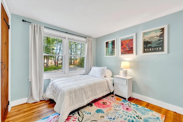 26 Beacon St, Amesbury, MA 01913 - bedroom featuring light wood finished floors and a barn door