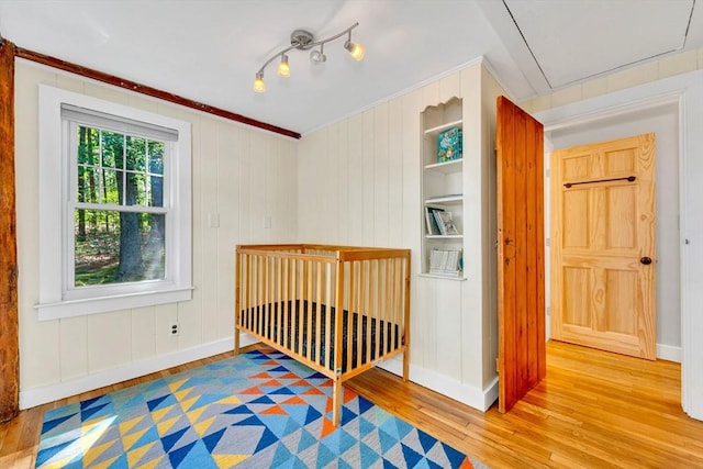 26 Beacon St, Amesbury, MA 01913 - unfurnished bedroom with wood-type flooring and attic access