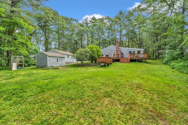 26 Beacon St, Amesbury, MA 01913 - view of green lawn with a deck and a storage unit