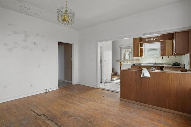 kitchen featuring hardwood / wood-style floors, hanging light fixtures, and a notable chandelier