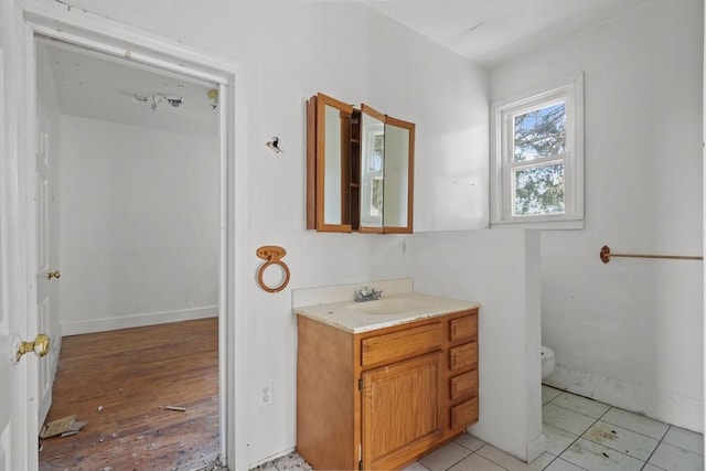 bathroom featuring tile patterned floors, vanity, and toilet