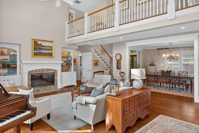 9 High Ridge Dr, Mattapoisett, MA 02739 - living area featuring a high ceiling, wood finished floors, stairs, a chandelier, and a fireplace