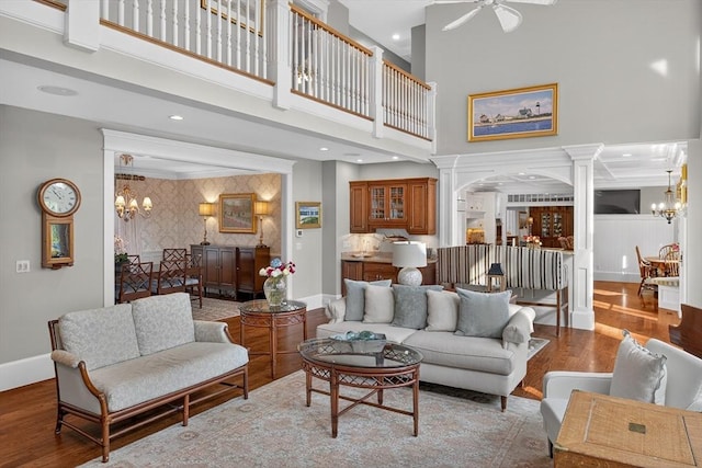 9 High Ridge Dr, Mattapoisett, MA 02739 - living area featuring a chandelier, a towering ceiling, wood finished floors, decorative columns, and a ceiling fan