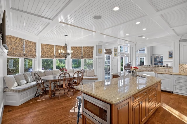 9 High Ridge Dr, Mattapoisett, MA 02739 - kitchen featuring stainless steel microwave, coffered ceiling, breakfast area, dark wood finished floors, and light stone countertops