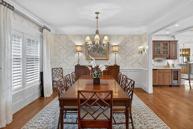9 High Ridge Dr, Mattapoisett, MA 02739 - dining area with a chandelier, wood finished floors, a decorative wall, wainscoting, and ornamental molding