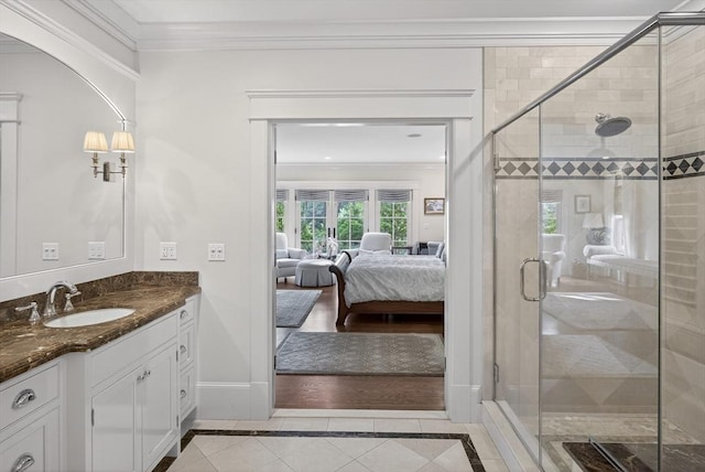 9 High Ridge Dr, Mattapoisett, MA 02739 - ensuite bathroom featuring inlaid floor details, vanity, crown molding, a stall shower, and tile patterned flooring