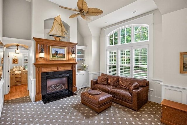 9 High Ridge Dr, Mattapoisett, MA 02739 - living room featuring high vaulted ceiling, a fireplace with flush hearth, ceiling fan, wainscoting, and carpet