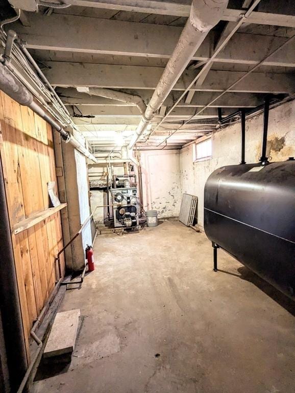 basement featuring a heating unit and heating fuel