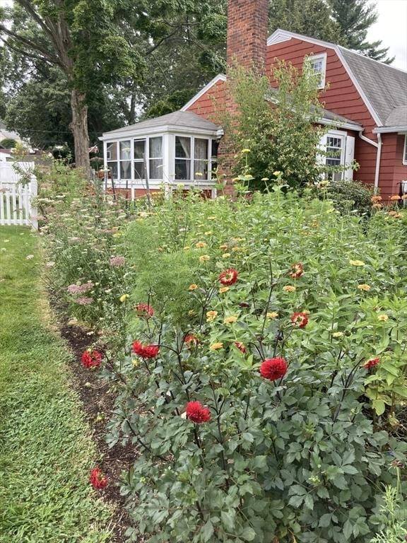 view of yard featuring a sunroom and fence