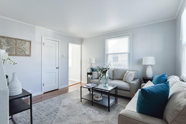 living room with baseboards, wood finished floors, and crown molding