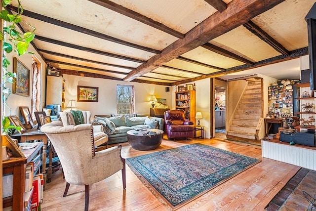 living room with beamed ceiling and hardwood / wood-style flooring