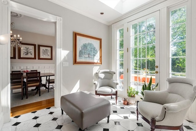 sitting room featuring crown molding and a chandelier