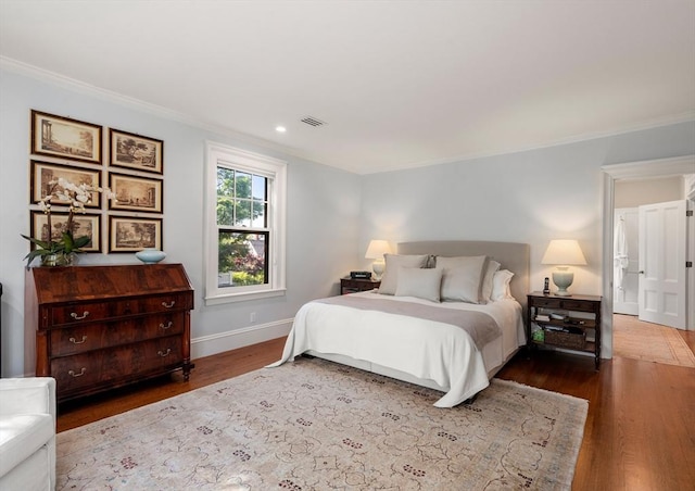 bedroom with ornamental molding, wood finished floors, baseboards, and recessed lighting