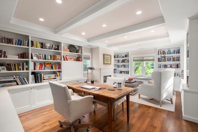 office with light wood-style floors, built in features, crown molding, beam ceiling, and recessed lighting
