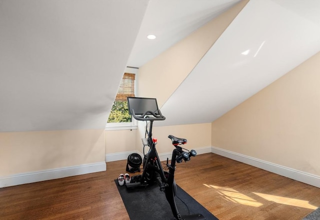 workout room with wood finished floors, baseboards, recessed lighting, and vaulted ceiling
