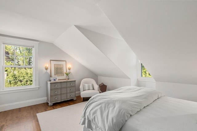 bedroom featuring vaulted ceiling, wood finished floors, and baseboards