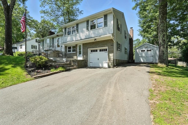 15 Oak Bluff Cir, East Longmeadow, MA 01028 - tri-level home with a shed, asphalt driveway, a chimney, a garage, and a front lawn