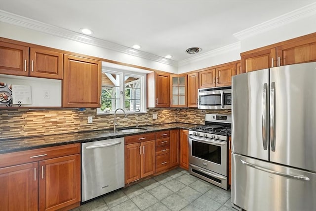 15 Oak Bluff Cir, East Longmeadow, MA 01028 - kitchen featuring stainless steel appliances, brown cabinets, ornamental molding, tasteful backsplash, and dark stone counters