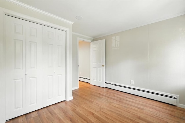 15 Oak Bluff Cir, East Longmeadow, MA 01028 - unfurnished bedroom with a baseboard radiator, light wood-type flooring, ornamental molding, and a closet